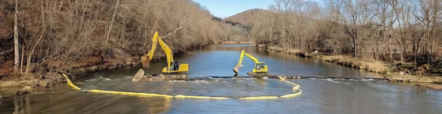 Excavator demolishing a low-head dam on the Mohican River in Brinkhaven, Ohio
