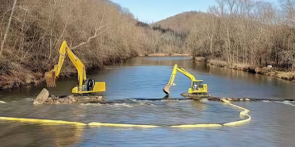 Excavator demolishing a low-head dam on the Mohican River in Brinkhaven, Ohio