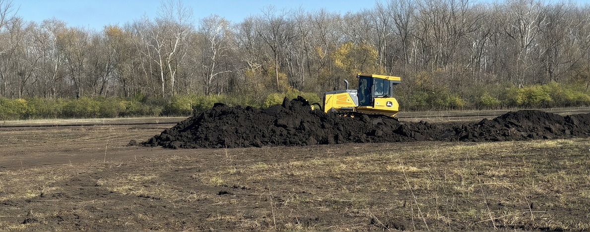 Native seeding and mulch stabilizing a completed wetland surface