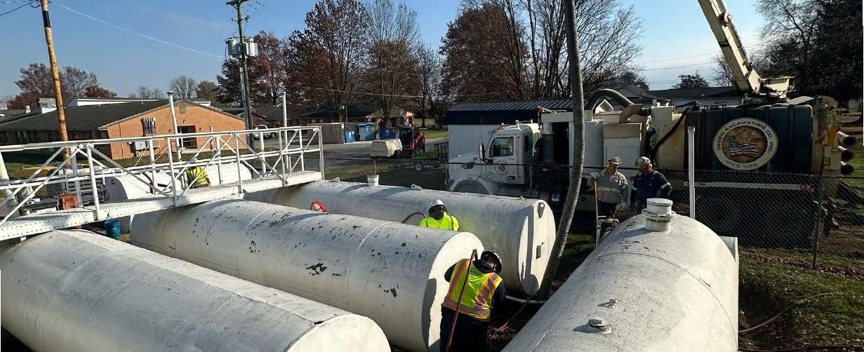 Hydrovac truck and ERC crew excavating diesel-impacted soil around aboveground fuel storage tanks during an emergency spill cleanup